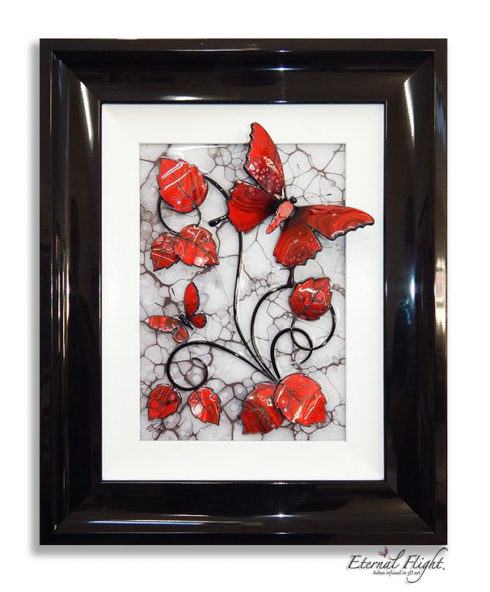 Black framed artwork of red butterflies and leaves against a white background