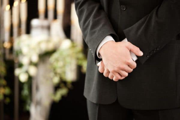 Hands Clasped Together In Front Of Man In Suit